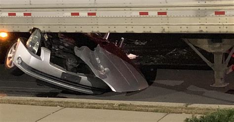 Man dies after car ends up wedged under semi-trailer, Aurora PD says